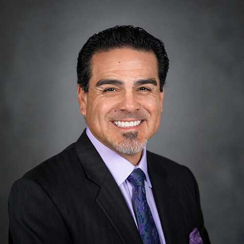 Headshot of Chris Garza, Executive Regional Manager. 